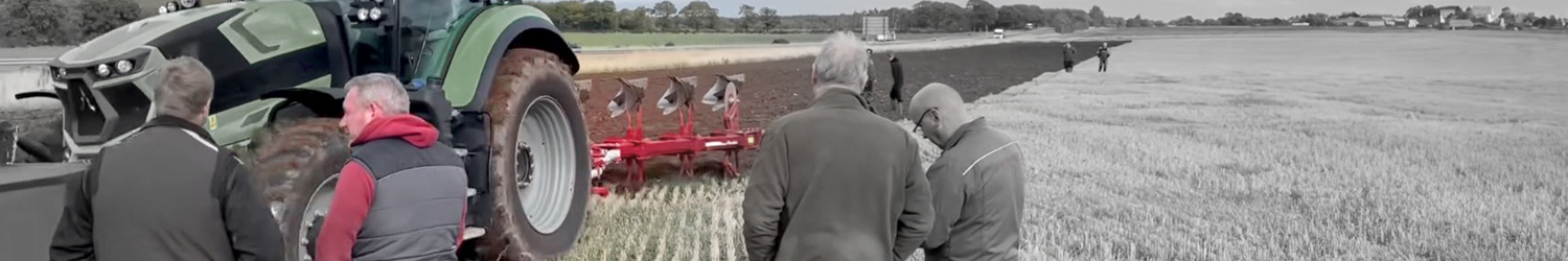 Farmers watching an Ovlac plough working in field banner