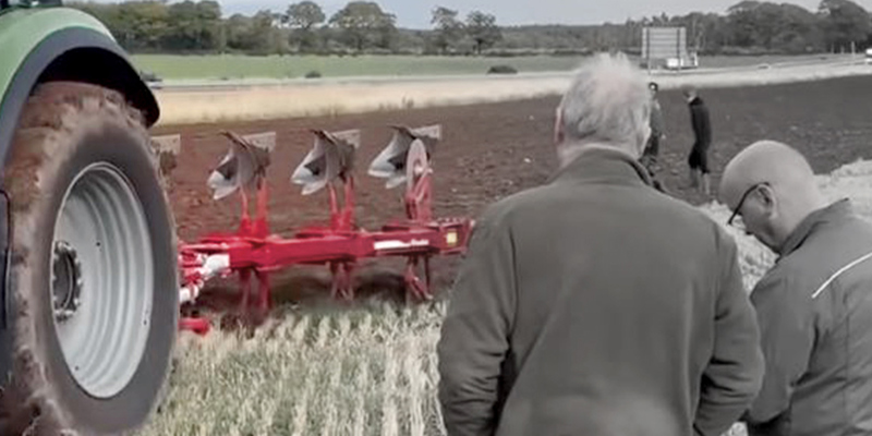 Farmers watching Ovlac plough at work behind a Deutz Fahr tractor